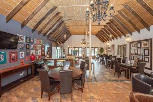 a restaurant with a dining room with tables and chairs at Onse Khaya Lodging and Conferencing in Port Elizabeth