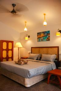 a bedroom with a large bed in a room at COCO CABANA in Palolem