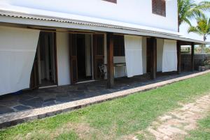 a side view of a house with a porch at Villa Palissandre in Nosy Be