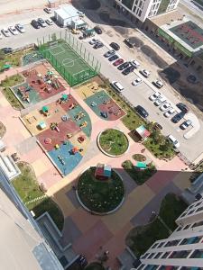 an aerial view of a parking lot with a tennis court at Altyn Dala in Taldykolʼ
