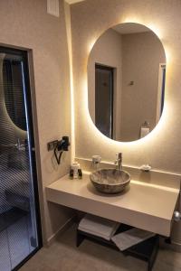 a bathroom with a sink with a large mirror at Belcekiz Beach Club - All Inclusive in Oludeniz