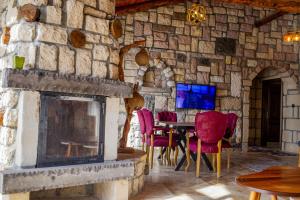 a stone room with a fireplace and a table and chairs at Amazing Stone House with Private Pool in Iznik in İznik