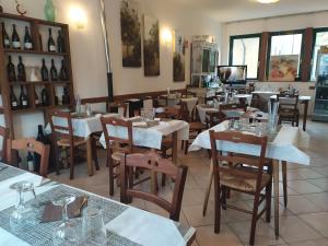 a restaurant with tables and chairs and a room filled with at Locanda Da Teresa in Bardineto