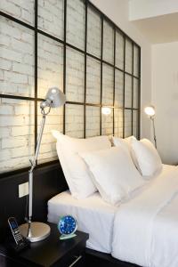 A bed or beds in a room at Magnova Studios