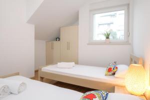 Postel nebo postele na pokoji v ubytování Apartments Tomana