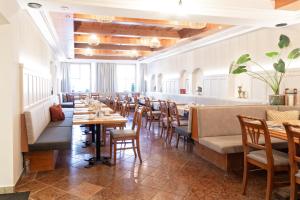 a row of tables and chairs in a restaurant at Gasthof Scherzl in Haag am Hausruck