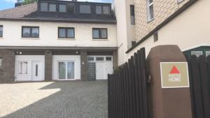 a house with a fence and a home hope sign at Monteurhome-Hagen in Hagen