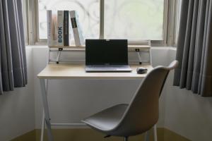 a desk with a laptop and a chair on it at Perfect Family Home 3B2b Taipei 101 & MRT-4 min 完美家庭住宅 3房2衛 4分到台北101 in Taipei