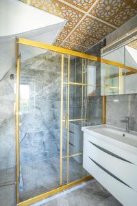 uma casa de banho com uma cabina de duche em vidro e um lavatório. em Villa Wonder em Dalyan