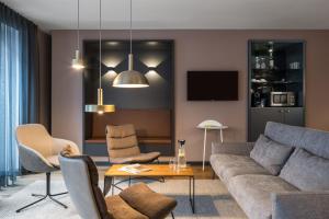 a living room with a couch and a table at ipartment Frankfurt Central Station in Frankfurt