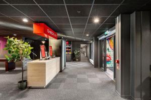 a lobby of a store with a counter in a building at Aiden by Best Western Trondheim Airport in Stjoerdal