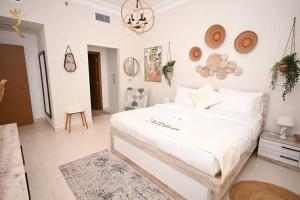 a bedroom with a large white bed in a room at Yas Natura Bliss 1BR Apartment in Abu Dhabi