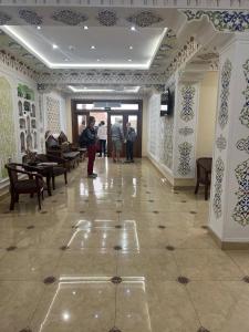 a hallway with people standing in a building at Sultan Hotel Boutique in Samarkand