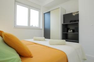 Postel nebo postele na pokoji v ubytování Apartments Tomana