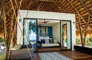 a bedroom in a resort with a bed and a mirror at The Resort at Isla Palenque Member of the Cayuga Collection in Boca Chica