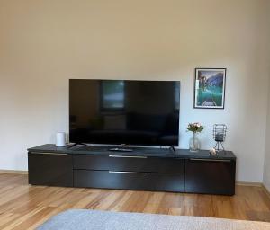 a black entertainment center with a large flat screen tv at Haus Gaberhel in Ellmau