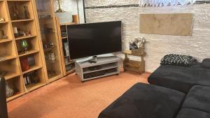 a living room with a large flat screen tv at Souterrainwohnung Zum Leiselsee in Baunatal