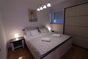 Postel nebo postele na pokoji v ubytování Apartments Tomana