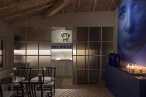 a dining room with two tables and chairs and candles at ELLE dimora di Sicilia in Catania
