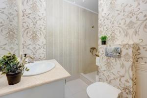 a bathroom with a sink and a shower at Beautiful 2BedFlatCismigiu in Bucharest +26 photos