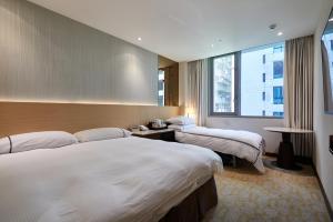 Postel nebo postele na pokoji v ubytování K Hotel Tianjin