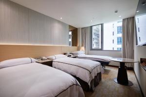 Postel nebo postele na pokoji v ubytování K Hotel Tianjin