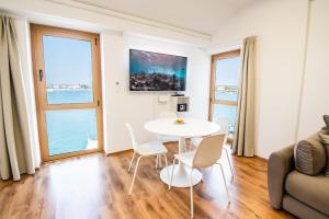 a living room with a table and chairs at Umag apartment center seafront seaview old town 2 by Rentistra in Umag
