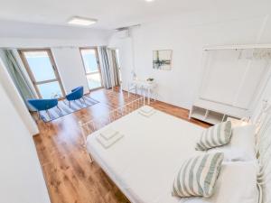 a living room with a white couch and blue chairs at Umag apartment center seafront seaview old town 2 by Rentistra in Umag