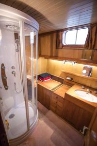 a large bathroom with a shower and a sink at Classic riverboat in the center of Paris in Paris