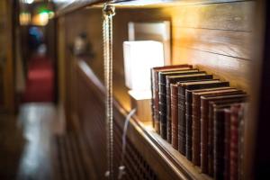 a row of books on a shelf in a room at Classic riverboat in the center of Paris in Paris