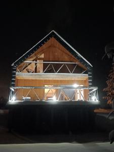 a house is lit up at night at Czarna Chata in Jaworzynka