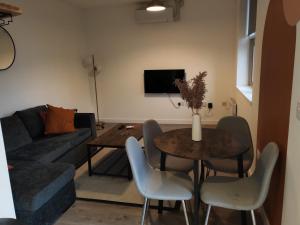 a living room with a table and a couch at 404 Bayard Plaza 2 Bedroom Apartment with Outside terrace in Peterborough