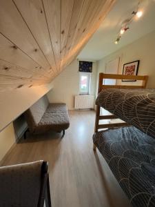 a room with two beds and a couch in it at vakantiewoning Heidehoek in Middelkerke