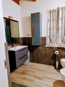 a bathroom with a sink and a mirror at CASA FIORENTINI CESENATICO in Cesenatico
