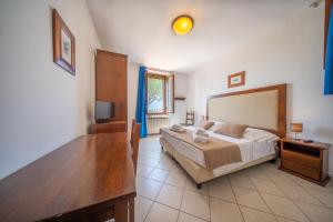 Postel nebo postele na pokoji v ubytování Resort Capalbio