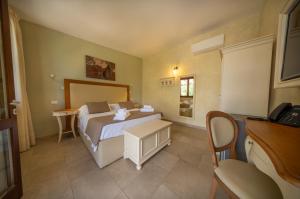 Postel nebo postele na pokoji v ubytování Resort Capalbio