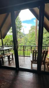 a view of a porch with benches and a fence at Fair View Cottage in Ella