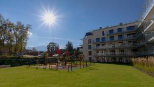 a park with a playground in front of a building at VacationClub - Apartamenty Zakopiańskie Apartament 214 in Zakopane
