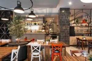 ein Restaurant mit Tischen und Stühlen und eine Küche in der Unterkunft Aparthotel Vanilla in Krakau