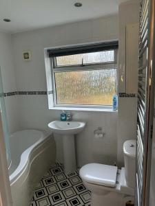 a bathroom with a sink toilet and a window at Wendover House 