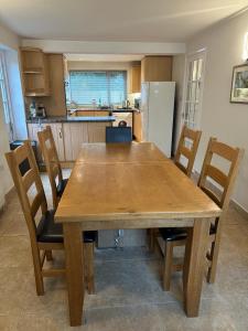 a wooden table and chairs in a kitchen at Wendover House 