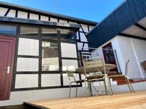 a patio with a table and chairs on a deck at eichHAUS Eifel in Rheinbach