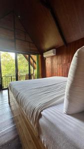 a large bed in a wooden room with at Fair View Cottage in Ella