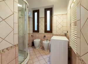 a bathroom with a toilet and a sink and mirror at Nice apartment in the heart of Porta Venezia in Milan