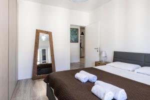 a bedroom with a large bed with towels on it at Nice apartment in the heart of Porta Venezia in Milan