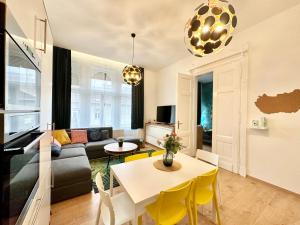 a living room with a couch and a table at Luxory Design Apartment#Bakáts#FreeParking#8ppl in Budapest