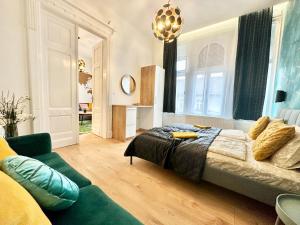 a bedroom with a bed and a couch at Luxory Design Apartment#Bakáts#FreeParking#8ppl in Budapest