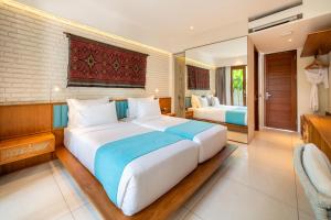 a large bedroom with two beds and a television at IZE Canggu by LifestyleRetreats in Canggu