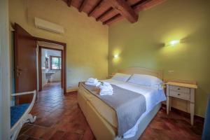 Postel nebo postele na pokoji v ubytování Resort Capalbio