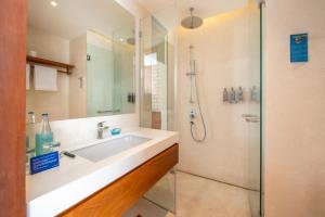 a bathroom with a sink and a shower at IZE Canggu by LifestyleRetreats in Canggu